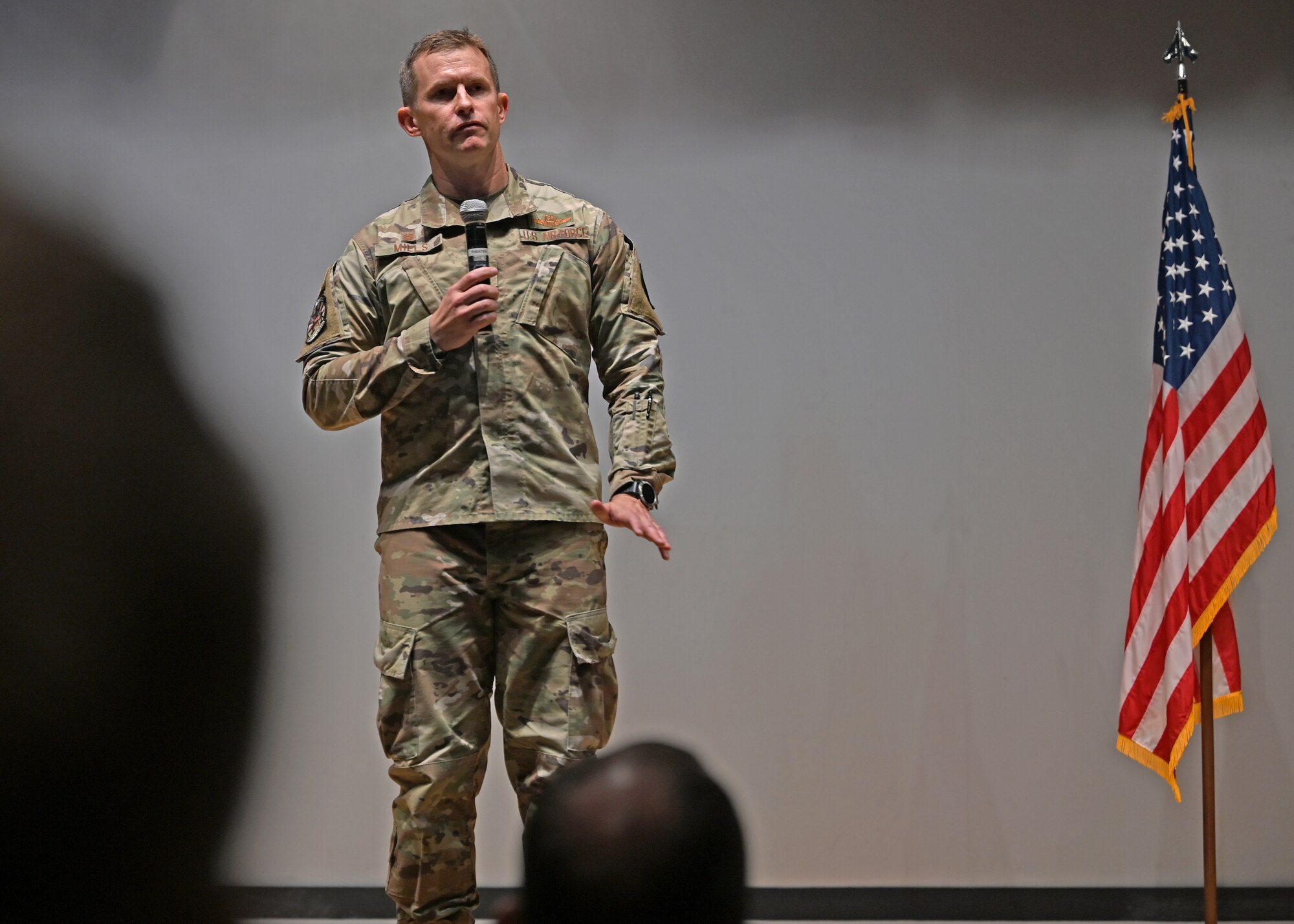 U.S. Air Force Col. Scott Mills, 355th Wing commander, speaks at a ceremony for two Bronze Star Medal recipients in the base theater at Davis-Monthan Air Force Base, Ariz., June 7, 2024. Two rescue Airmen were awarded the Bronze Star Medal for heroic service in a combat zone. (U.S. Air Force photo by Staff Sgt. Abbey Rieves)