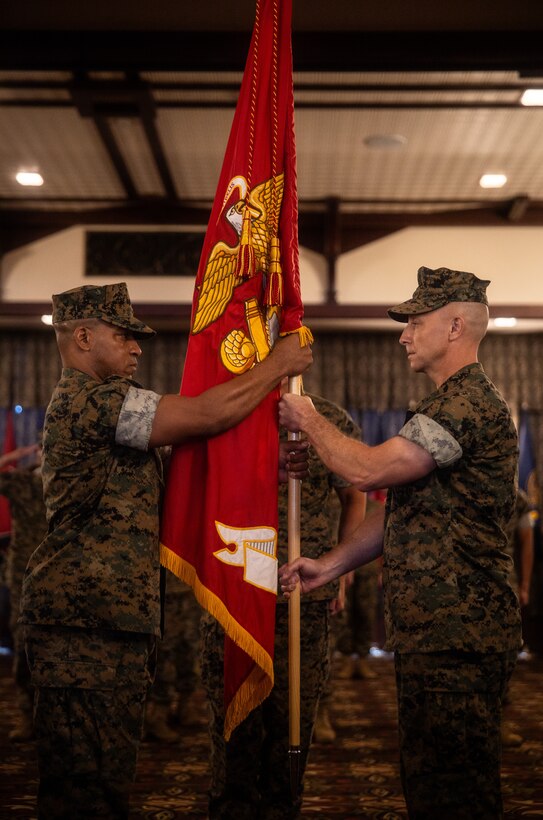 U.S. Marine Corps Col. Marc Walker, left, incoming commanding officer of Headquarters and Support Battalion, Marine Corps Installations Pacific, takes the battalion guidon from Col. David Banning, outgoing commanding officer of H&S Battalion, MCIPAC, during a change of command ceremony on Plaza Housing, Camp Foster, Okinawa, Japan, May 31, 2024. Banning served for two years as the commanding officer and was relieved by Walker, who previously served as the commanding officer of 3rd Network Battalion, MCIPAC, and most recently as the Assistant Chief of Staff G6. Banning is a native of Oregon and Walker is a native of Virginia. (U.S. Marine Corps photo by Sgt. Maximiliano)