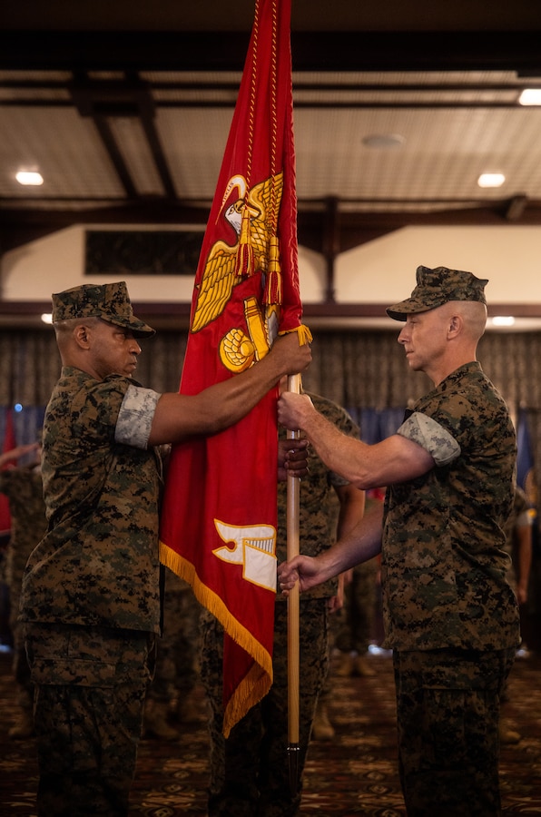 U.S. Marine Corps Col. Marc Walker, left, incoming commanding officer of Headquarters and Support Battalion, Marine Corps Installations Pacific, takes the battalion guidon from Col. David Banning, outgoing commanding officer of H&S Battalion, MCIPAC, during a change of command ceremony on Plaza Housing, Camp Foster, Okinawa, Japan, May 31, 2024. Banning served for two years as the commanding officer and was relieved by Walker, who previously served as the commanding officer of 3rd Network Battalion, MCIPAC, and most recently as the Assistant Chief of Staff G6. Banning is a native of Oregon and Walker is a native of Virginia. (U.S. Marine Corps photo by Sgt. Maximiliano)