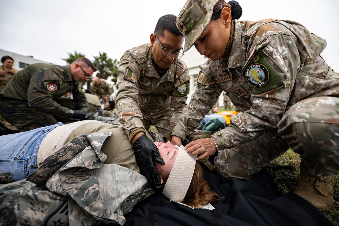 Peruvian Army medical professionals conduct Tactical Combat Casualty Care (TCCC) on a U.S. Air Force Airman assigned to the 167th Aeromedical Evacuation Squadron from McLaughlin Air National Guard Base, West Virginia, as part of exercise Resolute Sentinel 2024 at Las Palmas Air Base in Lima, Peru, June 4, 2024. The TCCC course, led by U.S. Air Force aeromedical personnel, aimed to enhance the medical readiness and interoperability of the participating countries, ensuring they are better prepared to handle combat injuries in various operational scenarios. The Resolute Sentinel exercise honors the U.S. promise to be a trusted partner in the region by increasing collaboration, enhancing interoperability, and building partner nation capacity so that partners can quickly work together when support is needed. (U.S. Air Force photo by Tech. Sgt. Devin Boyer)