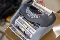 A currency counting machine counts training currency during exercise Diamond Saber at Joint Base McGuire-Dix-Lakehurst, New Jersey, June 8, 2024. Established in 2004 and celebrating its 20th iteration, Diamond Saber is a U.S. Army Reserve-led exercise that trains and evaluates Active and Reserve Component Soldiers and joint partners on warfighting functions such as funding the force, payment support, disbursing operations, accounting, fiscal stewardship, auditability and data analytics. (U.S. Army photo by Mark R. W. Orders-Woempner)