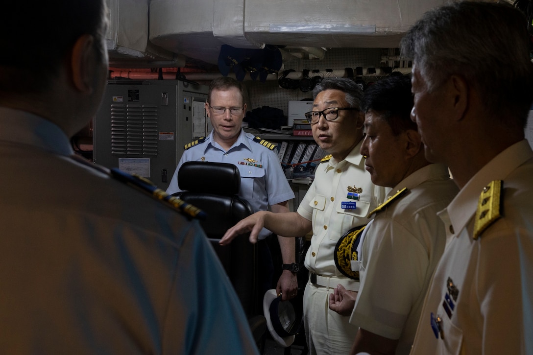 U.S. Coast Guard Capt. Tyson Scofield, commanding officer of the U.S. Coast Guard Cutter Waesche (WMSL-751), center, talks to members of the Japan Coast Guard during a ship tour aboard the Waesche, in Maizuru, Japan, June 5, 2024. Capt. Scofield guided leaders from the Japan Coast Guard through the ship, highlighting its capabilities and mission sets. The U.S. Coast Guard has operated in the Indo-Pacific for more than 150 years, and the service is increasing efforts through targeted patrols with our National Security Cutters, Fast Response Cutters and other activities in support of Coast Guard missions to enhance our partnership. (U.S. Marine Corps photo by Cpl. Elijah Murphy)