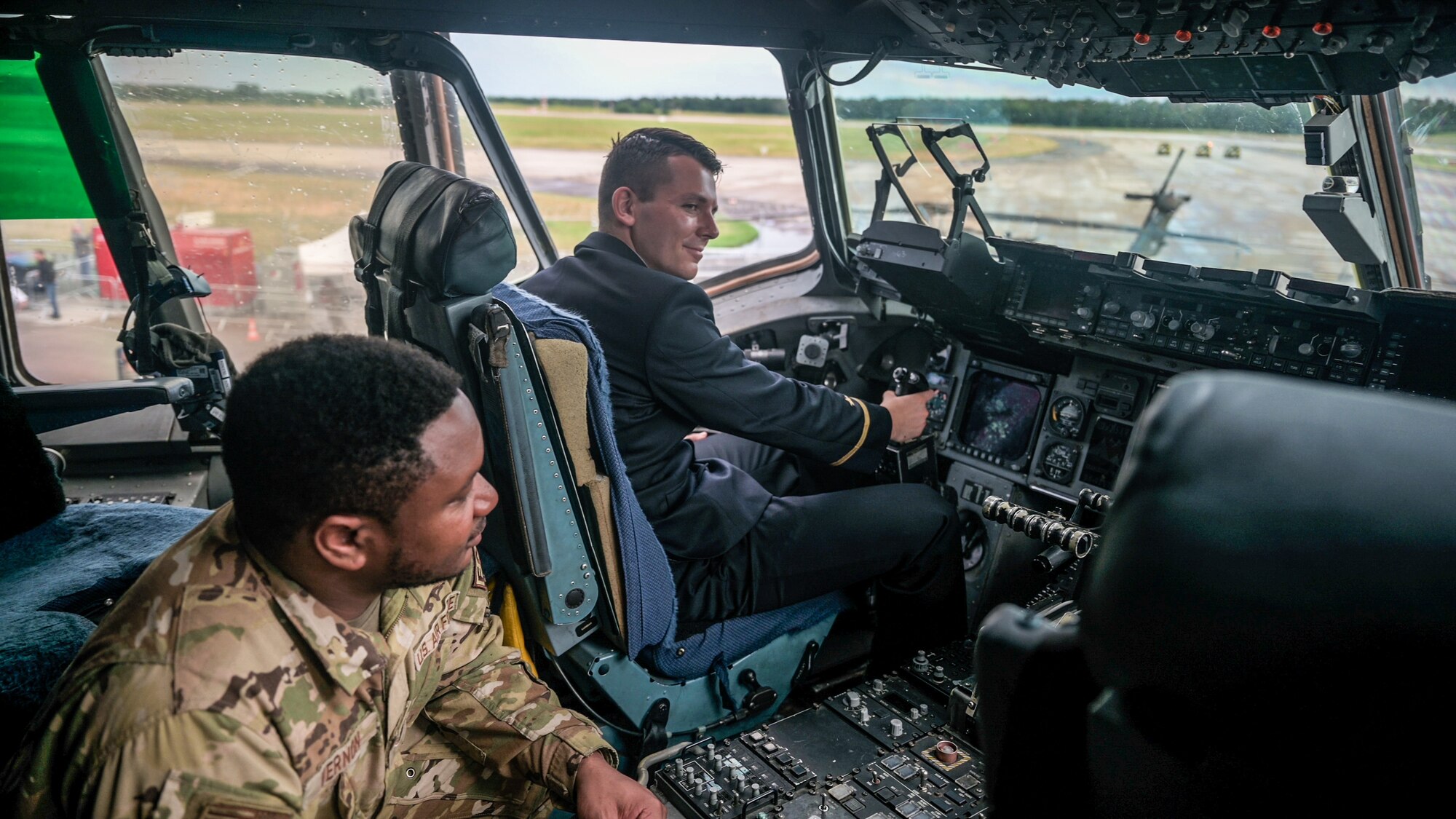 Tech. Sgt. Jeremy Vernon, Flying Crew Chief with Joint Base Charleston's 437th Aircraft Maintenance Squadron, explains items in the cockpit of a U.S. Air Force C-17 Globemaster III cargo aircraft to interested visitors at the ILA Berlin 2024 Air Show in Berlin, Germany, June 5, 2024. A team led by the Air Force Reserve 315th Airlift Wing showcased the large cargo aircraft as a static display during the air show, which is one of the largest in the world. (U.S. Air Force photo by Tech. Sgt. Della Creech)