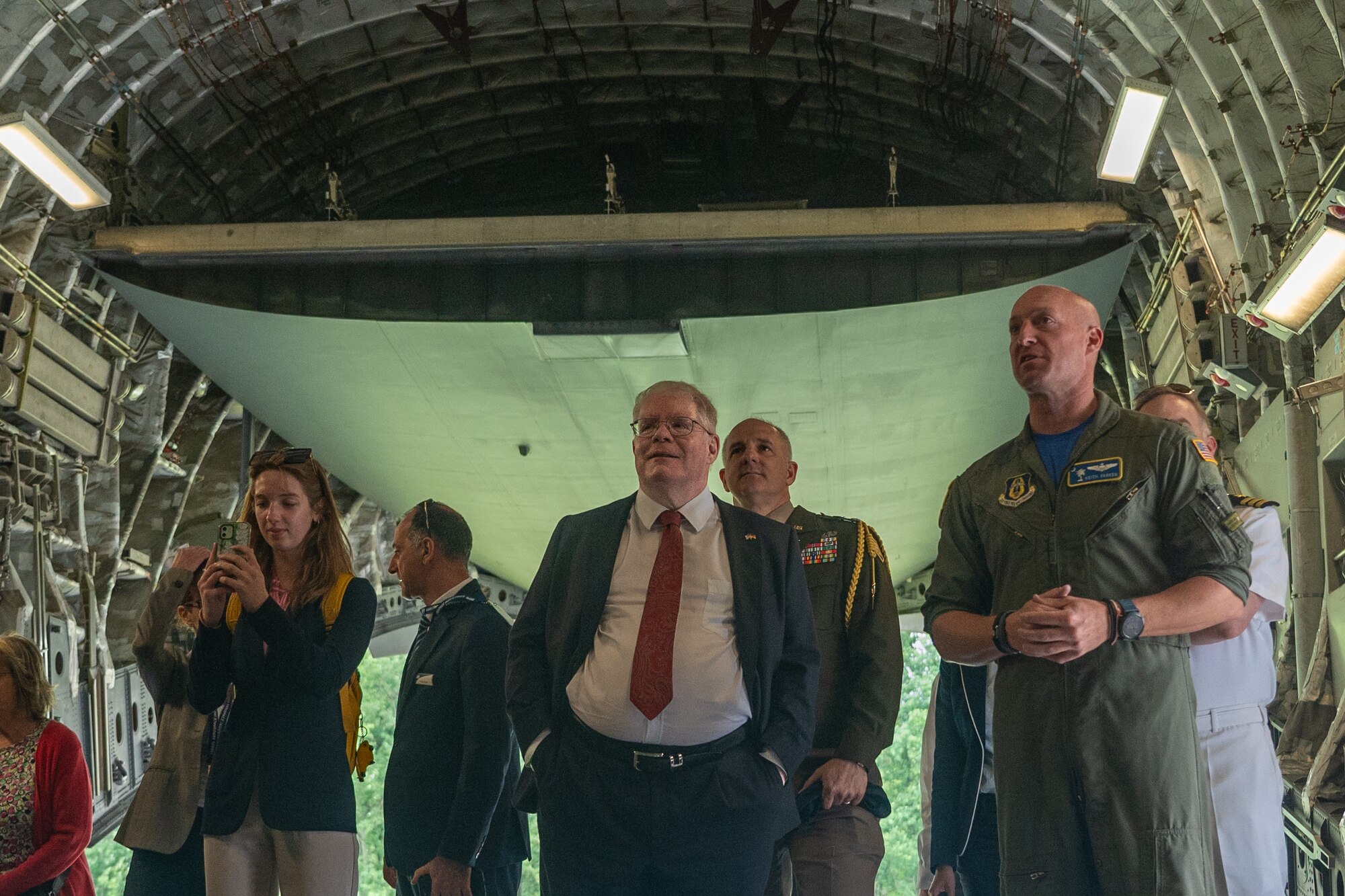 U.S. Air Force Reserve pilot Maj. Keith Parker, at right, briefs distinguished visitor Mr. Woodward Clark Price, Deputy Chief of Mission at the U.S. Embassy to Germany, in the cargo area of a C-17 Globemaster III strategic airlift aircraft during the ILA Berlin 2024 Air Show held in Berlin, Germany, June 5, 2024. Parker is a C-17 pilot with the 300th Airlift Squadron, a component of the Air Force Reserve 315th Airlift Wing, based at Joint Base Charleston, South Carolina. (U.S. Air Force photo by Tech. Sgt. Della Creech)