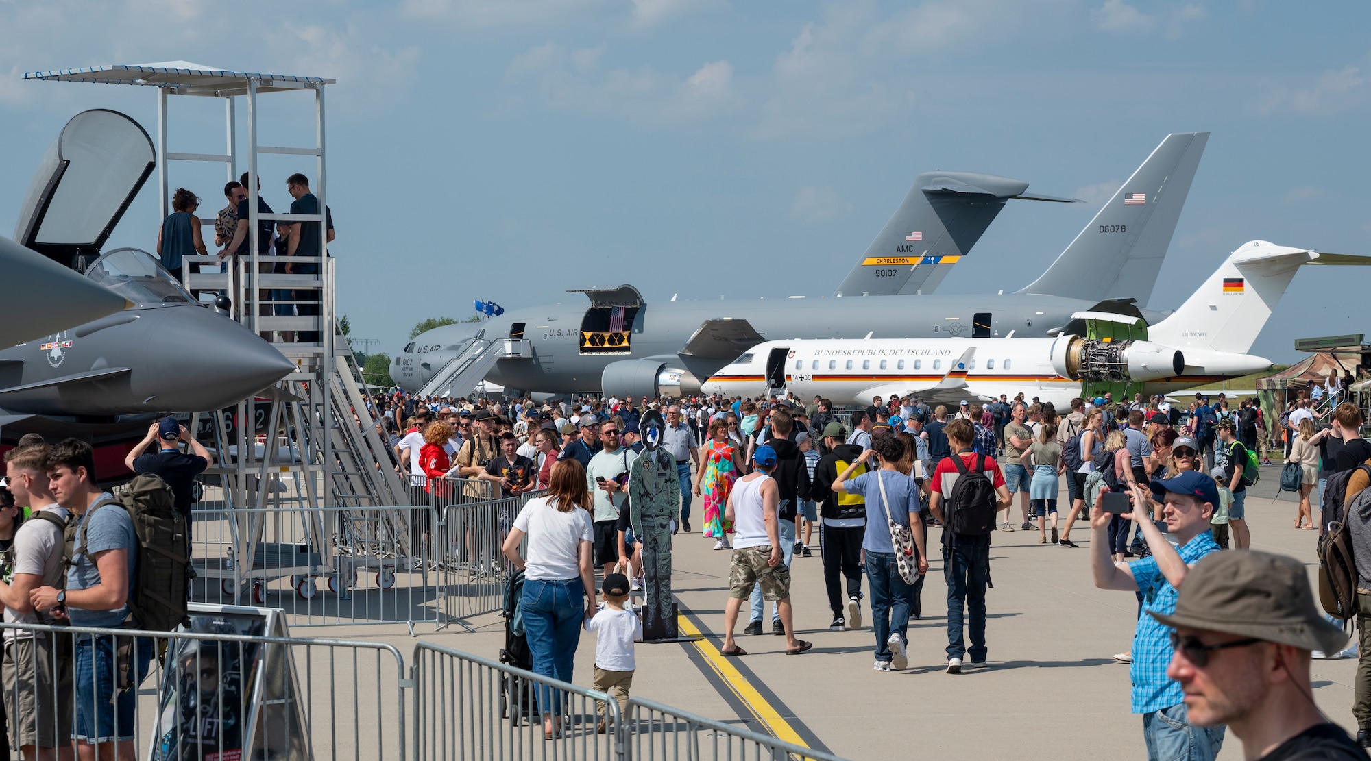 The tail of a Joint Base Charleston C-17 Globemaster III is visible above other aircraft showcased at the ILA Berlin 2024 Air Show in Berlin, Germany, June 8, 2024. Over 85,000 attendees, trade show expositors, and aircrew visited the 5-day air show and trade show held at Berlin Brandenburg Airport. (U.S. Air Force photo by Capt. Justin Clark)