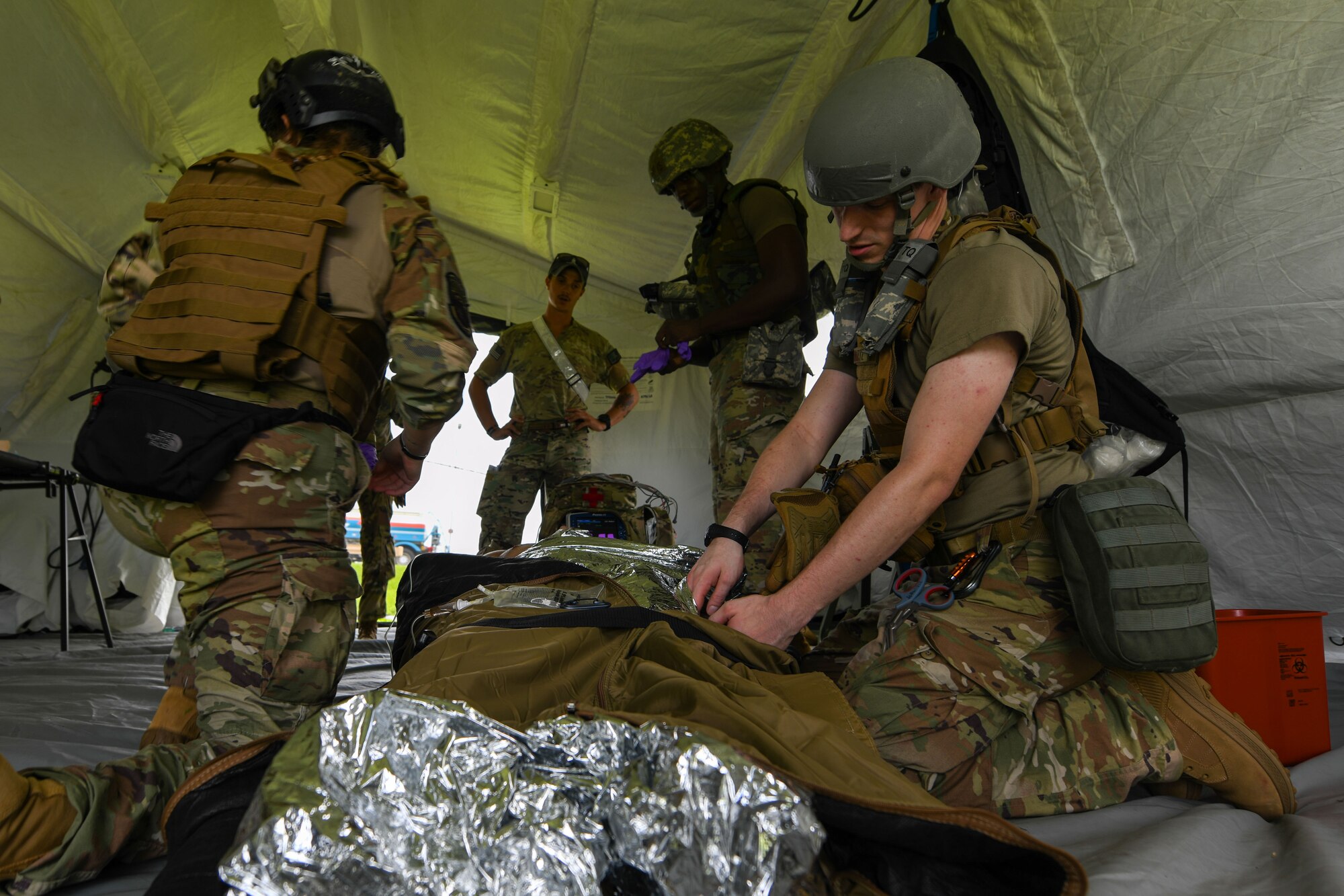 U.S. Service Members treat a patient during a mass casualty exercise.