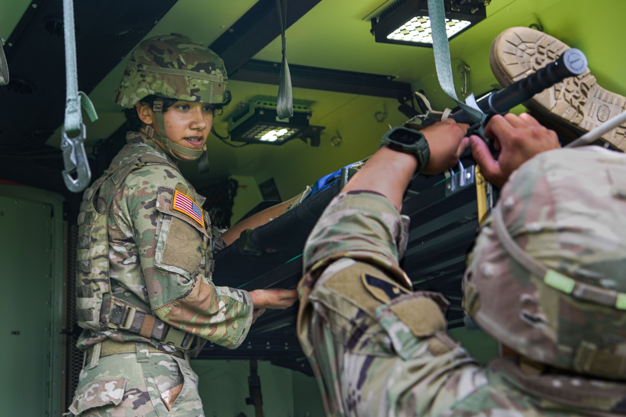 U.S. Army Soldiers unloads a patient from a transport vehicle.