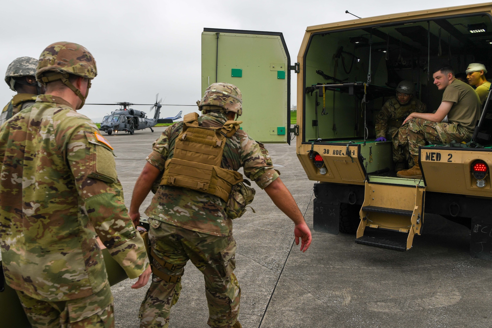 U.S. service members load patients into a transport vehicle.