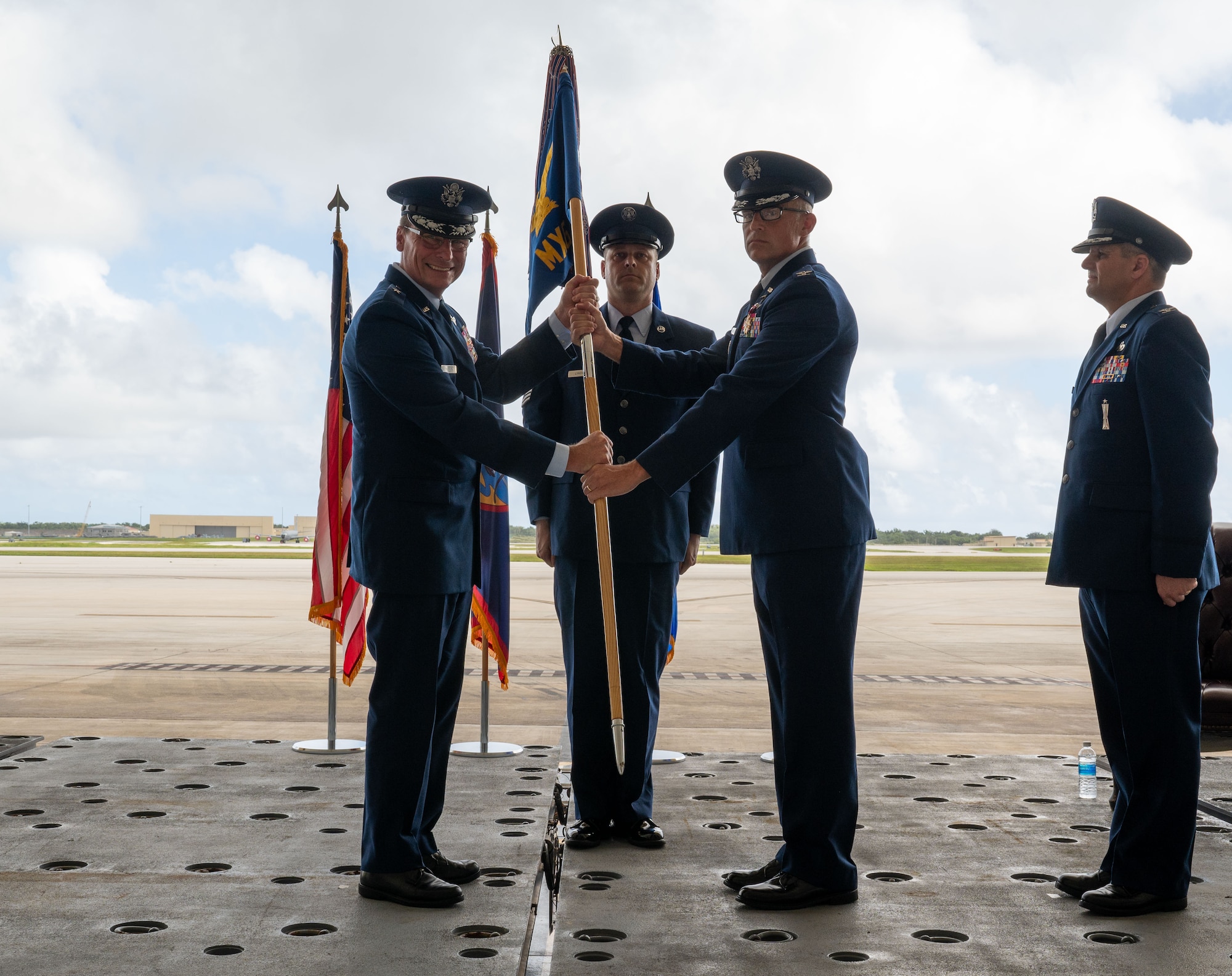 U.S. Air Force Col. James Hendrickson, 36th Maintenance Group commander, passes the guidon to Brig. Gen. Thomas Palenske, 36th Wing Commander during the Maintenance Group change of command ceremony at Andersen Air Force Base, Guam, June 5, 2024. In a change of command ceremony, the guidon symbolizes the transfer of command and the responsibility associated with it. (U.S. Air Force Photo by Airman 1st Class Manasseh Demissie)