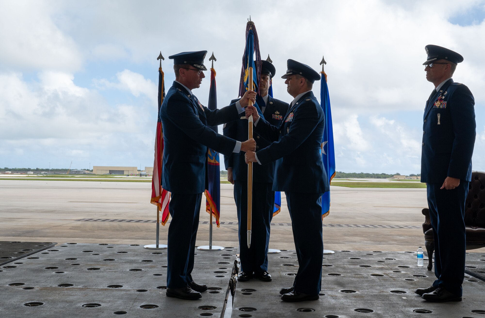 U.S. Air Force Brig. Gen. Thomas Palenske, 36th Wing Commander, passes the guidon to incoming commander of the 36th Maintenance Group Col. Matthew Drossner, at Andersen Air Force Base, Guam, June 5, 2024. The passings of colors to commanders ensure the unit and its airmen are never without official leadership. (U.S. Air Force Photo by Airman 1st Class Manasseh Demissie)