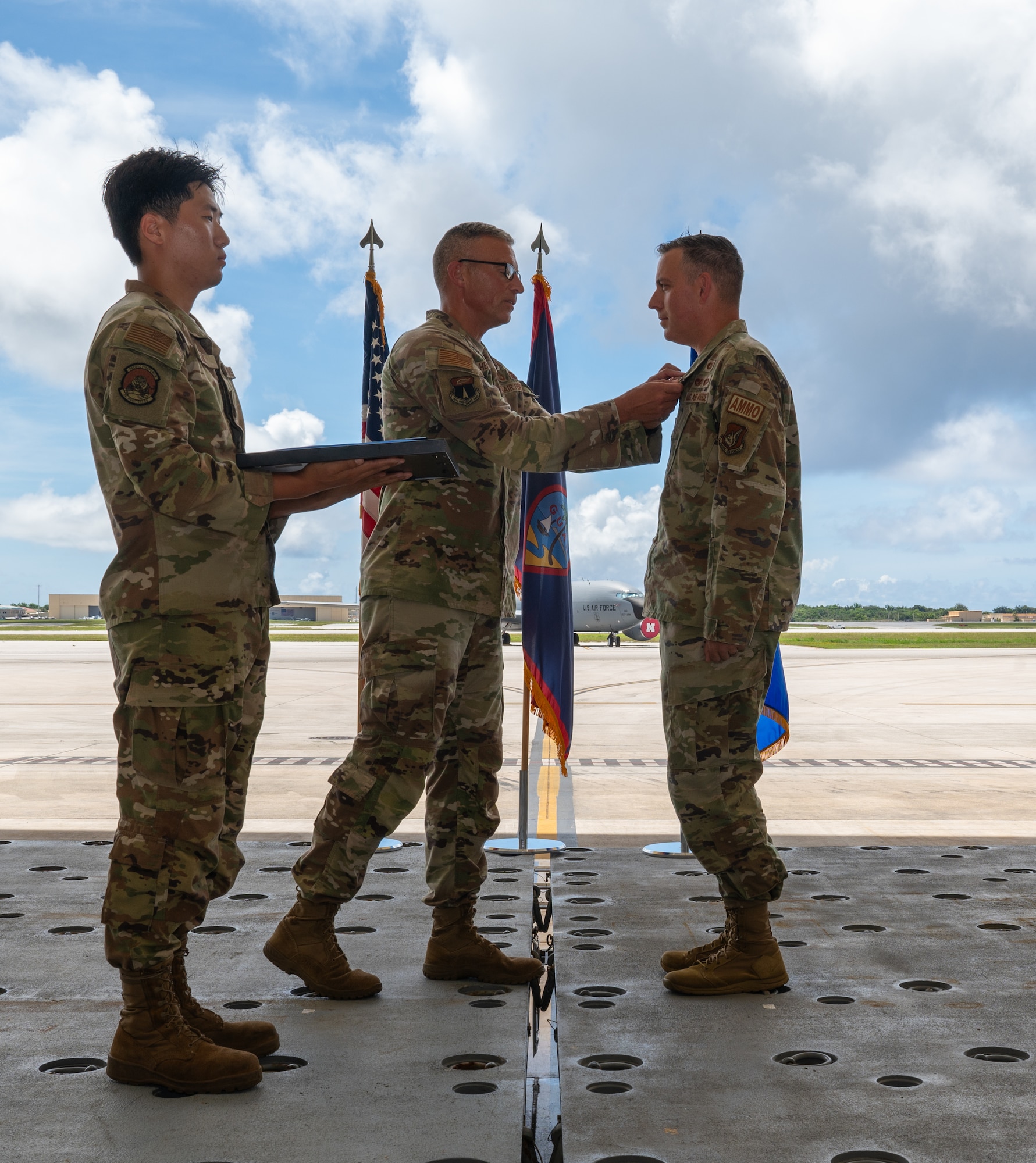 U.S. Air Force Col. James Hendrickson, 36th Maintenance Group Commander, pins a medal on the outgoing 36th Munitions Squadron commander Maj. Ryan Chapman, during the 36th Munitions Change of Command at Andersen Air Force Base, Guam, June 5, 2024.  The ceremony marks a formal passing of responsibility of command. (U.S. Air Force Photo by Airman 1st Class Manasseh Demissie)