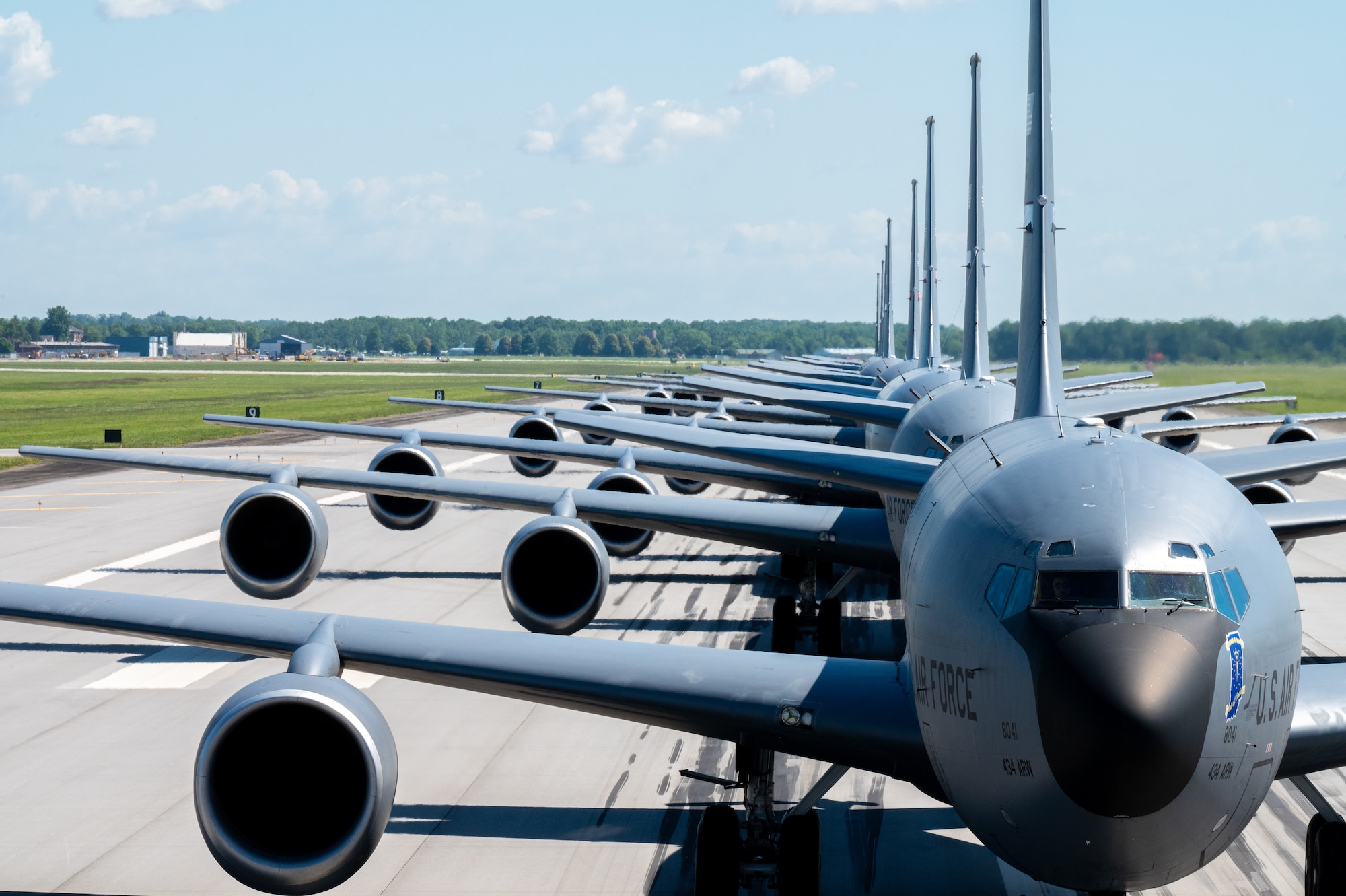 Eight KC-135R Stratotankers in a single-file line, each with their front-end visible in the photograph.
