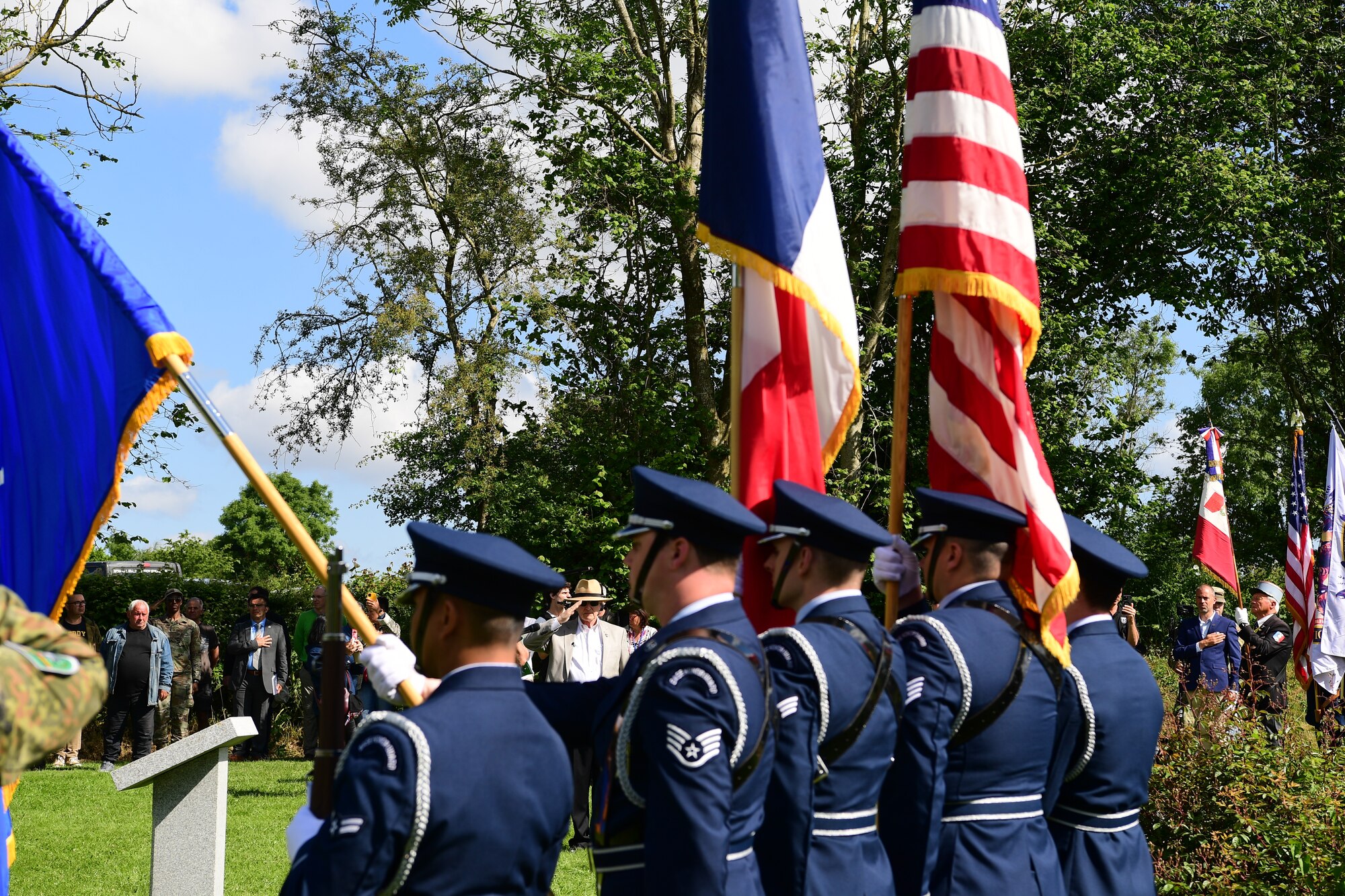 Retired Col. Paul Herbert, military historian, salutes during the playing of the French national anthem during a C-47 Memorial Garden Ceremony in Picauville, France, June 7, 2024. The memorial garden is decorated with 20 tulip trees and an outline of a C-47 to honor the lives of the service members lost 80 years ago. (U.S. Air Force photo by Senior Airman Noah Sudolcan)