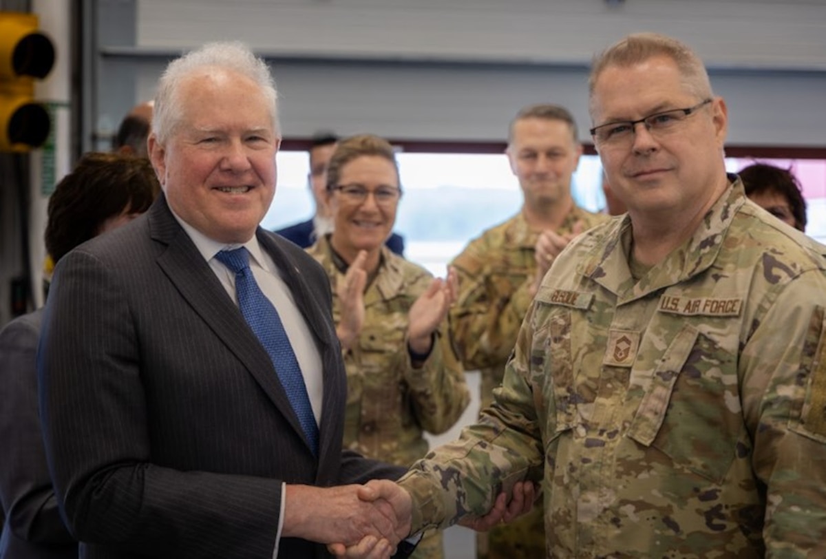 Secretary of the Air Force Frank Kendall presents a challenge coin to Senior Master Sgt. Joseph Busque, 101st Air Refueling Wing inspector general superintendent, as Brig. Gen. Diane Dunn, Maine adjutant general, and Col. Byron Newell, 101st ARW commander, applaud Busque’s accomplishments at the 101st ARW, Bangor, Maine, June 7, 2024.