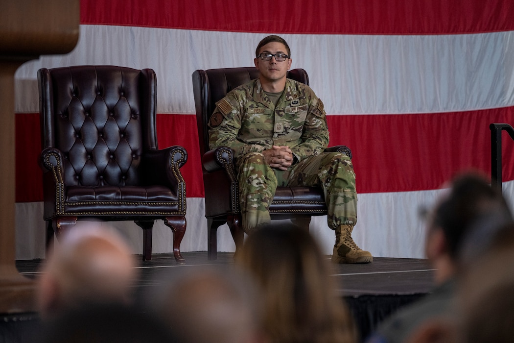 U.S. Air Force Master Sgt. Peter Pease, 23rd Fighter Group first sergeant, listens to opening remarks during a Bronze Star presentation at Moody Air Force Base, Georgia, May 23, 2024. Master Sgt. Peter J. Pease distinguished himself by meritorious achievement as Security Forces superintendent, 443d Air Expeditionary Squadron, 387th Air Expeditionary Group, Al Asad Air Base, Iraq while engaged in military operations against the opposing armed forces of Da'esh and Iranian Affiliated Militia Groups from April 16, 2023 to October 26, 2023. (U.S. Air Force photo by Senior Airman Deanna Muir)