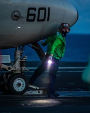 ABEAN Lilly Phillips checks an E-2D Hawkeye from VAW-125 during flight operations supporting Valiant Shield 2024 aboard USS Ronald Reagan (CVN 76) in the Philippine Sea.