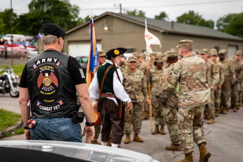 Retired U.S. Army Sgt. 1st Class Richard Walsh, a retiree from the 138th Field Artillery Brigade, watches Soldiers of the 103rd Brigade Support Battalion, 138th Field Artillery Brigade, prepare for the parade in Harrodsburg, Kentucky on June 8, 2024. The 103rd BSB supported the 250th anniversary of the settlement of Harrodsburg by participating in posting the colors, marching in the parade, and providing a static display of military vehicles. (U.S. Army National Guard photo by Sgt. 1st Class Andrew Dickson)