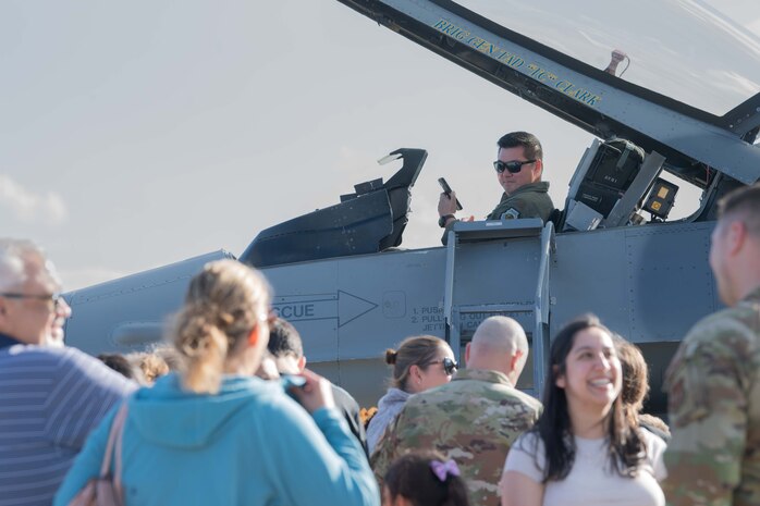U.S. Air Force Maj. Terry Wu, U.S. Air Forces in Europe - Air Forces Africa chief of C-130 Hercules weapons and tactics, observe members of the community after conducting a tour of the aircraft during Ramstein 1v1 at Ramstein Air Base, Germany, June 6, 2024. Ramstein 1v1 is USAFE-AFAFRICA's first-ever basic fighter maneuvers exercise at Ramstein AB, during which military aviators from nine NATO countries engaged in a friendly, tactical exercise to test their rapid decision-making and precise reactions to adversary maneuvers in a high-pressure, demanding setting. (U.S. Air Force photo by Airman 1st Class Trevor Calvert)