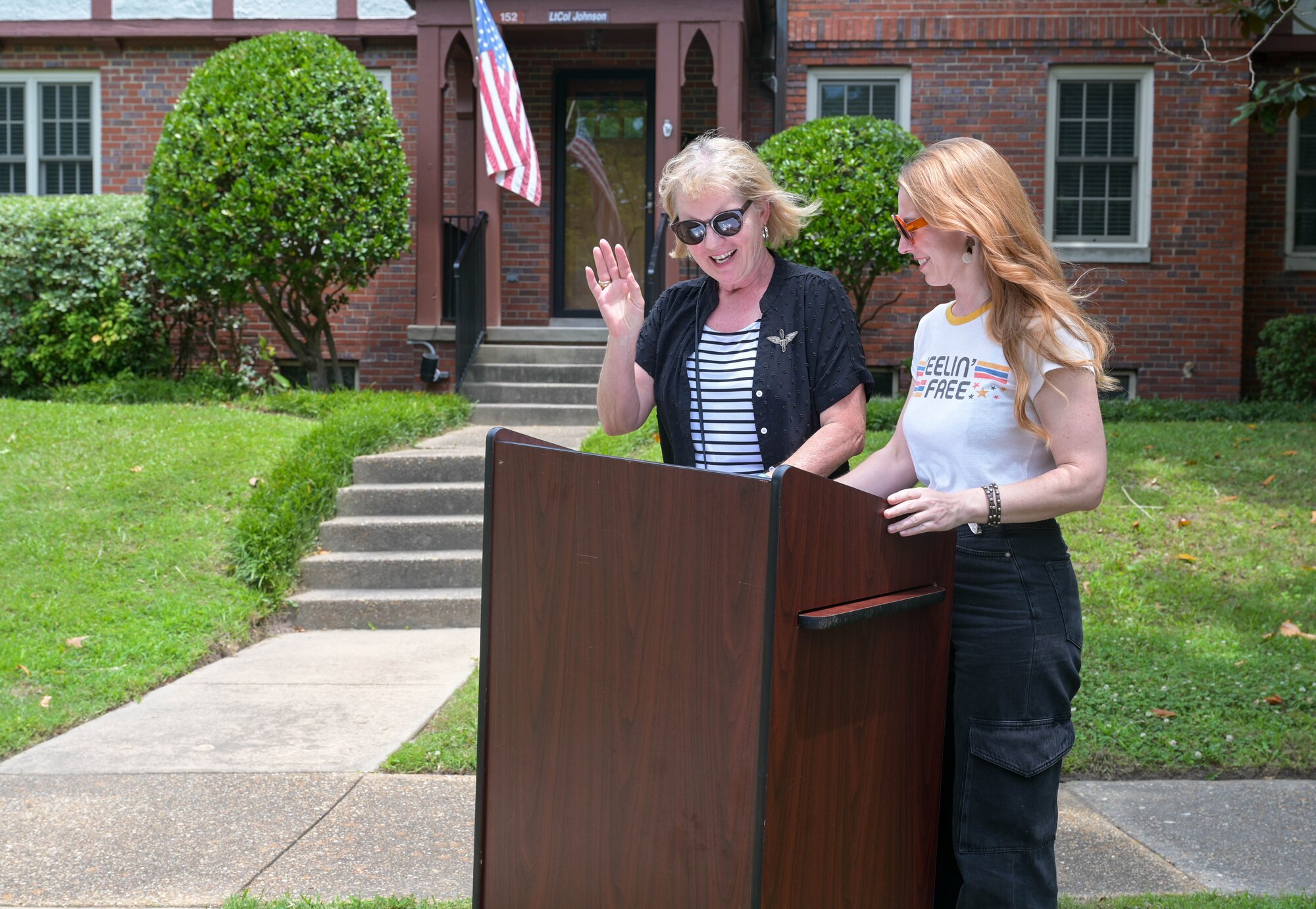 Christina Olds, author of ‘Fighter Pilot: The Memoirs of Legendary Ace Robin Olds,’ and her daughter Jennifer Newman, gives a speech during the house dedication ceremony, at Joint Base Langley-Eustis, Virginia, June 6, 2024. Olds talked about her experience growing up with both a grandfather and father that served as fighter pilots stationed at JBLE and the impact their leadership had on her. (U.S. Air Force photo by Airman 1st Class Adisen Smith)