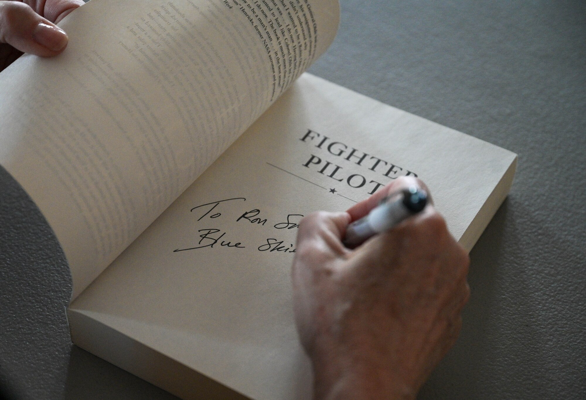Author signing a book.