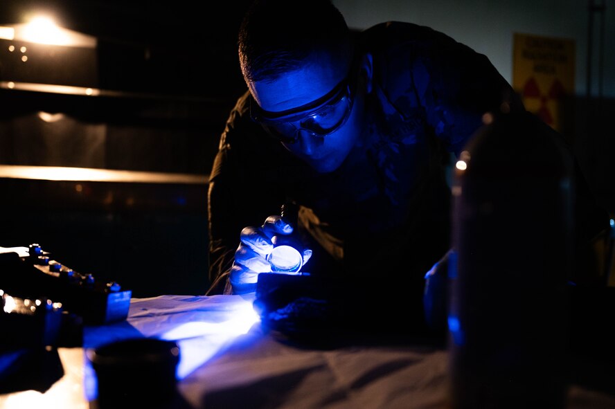 U.S. Air Force Senior Airman Jonathan Macias, 5th Maintenance Squadron non-destructive inspection (NDI) journeyman, conducts a magnetic particle inspection on a MHU-97/E part at Minot Air Force Base, North Dakota, June 6, 2024. NDI has a variety of inspection methods, to include fluorescent penetrant, magnetic particles, x-ray, ultrasound, oil analysis and eddy current. (U.S. Air Force photo by Airman 1st Class Luis Gomez)
