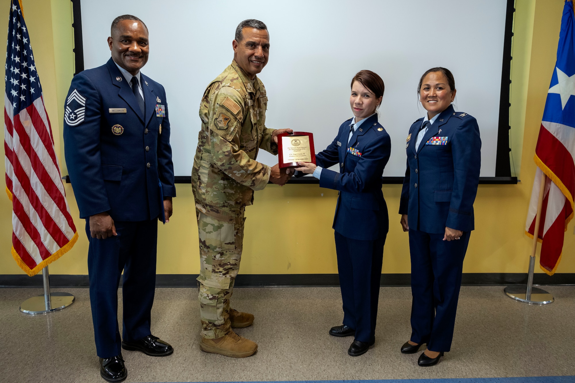 U.S. Air Force Col. Evaristo Orengo, commander of the 156th Wing, Puerto Rico Air National Guard, and leadership with the Air National Guard Chaplain Corps, presents the Samuel Stone Award to Maj. Iraida M. Alvarez Carrasquillo, the 156th Wing chaplain, PRANG, during a ceremony at Muñiz Air National Guard Base, Carolina, Puerto Rico, June 1, 2024. During the ceremony, Alvarez received the Samuel Stone Award, recognizing her as the outstanding Air National Guard Chaplain of the Year. (U.S. Air National Guard photo by Airman 1st Class Marrissa L. Rodriguez)