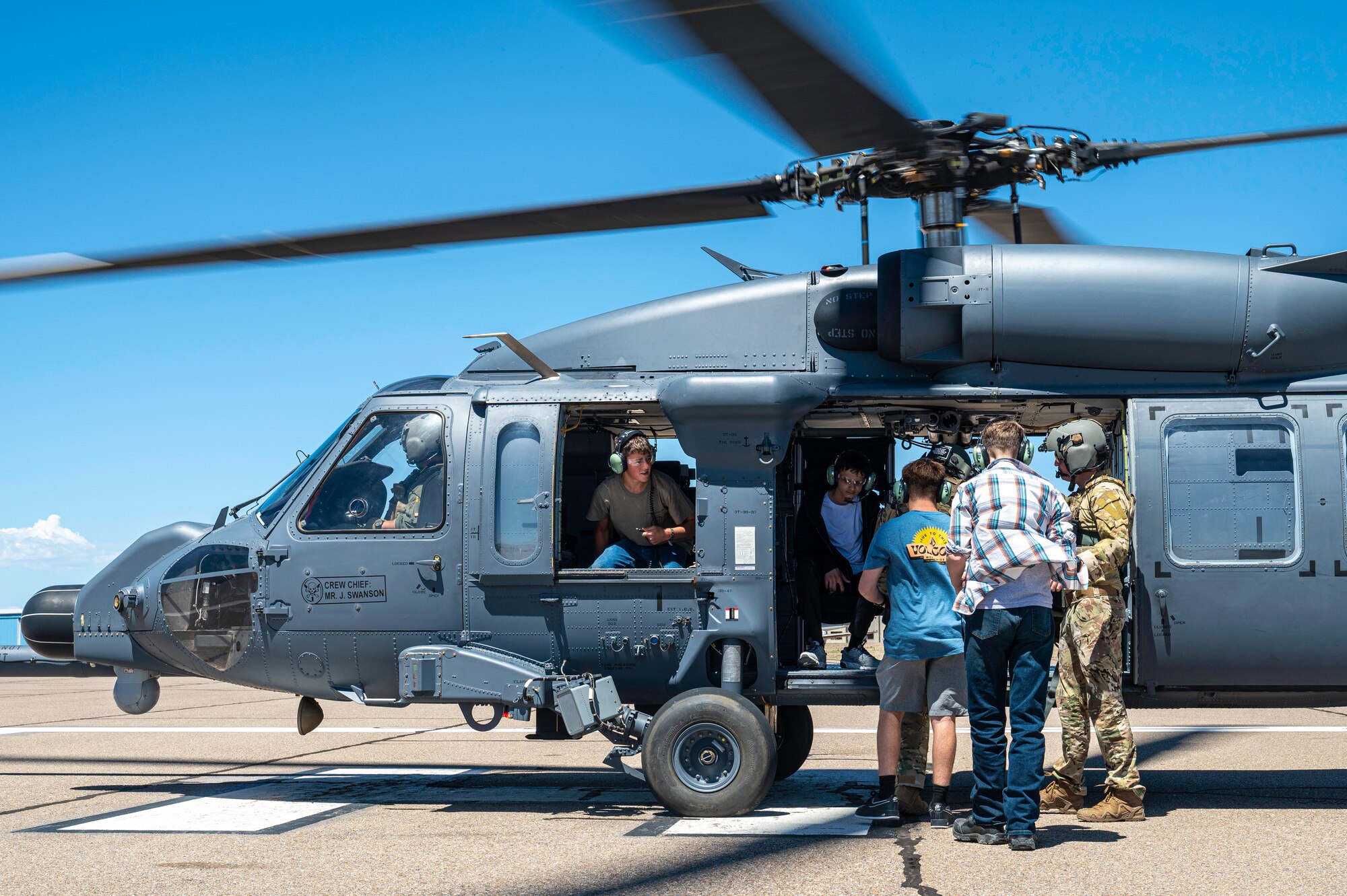 Students board a helicopter.