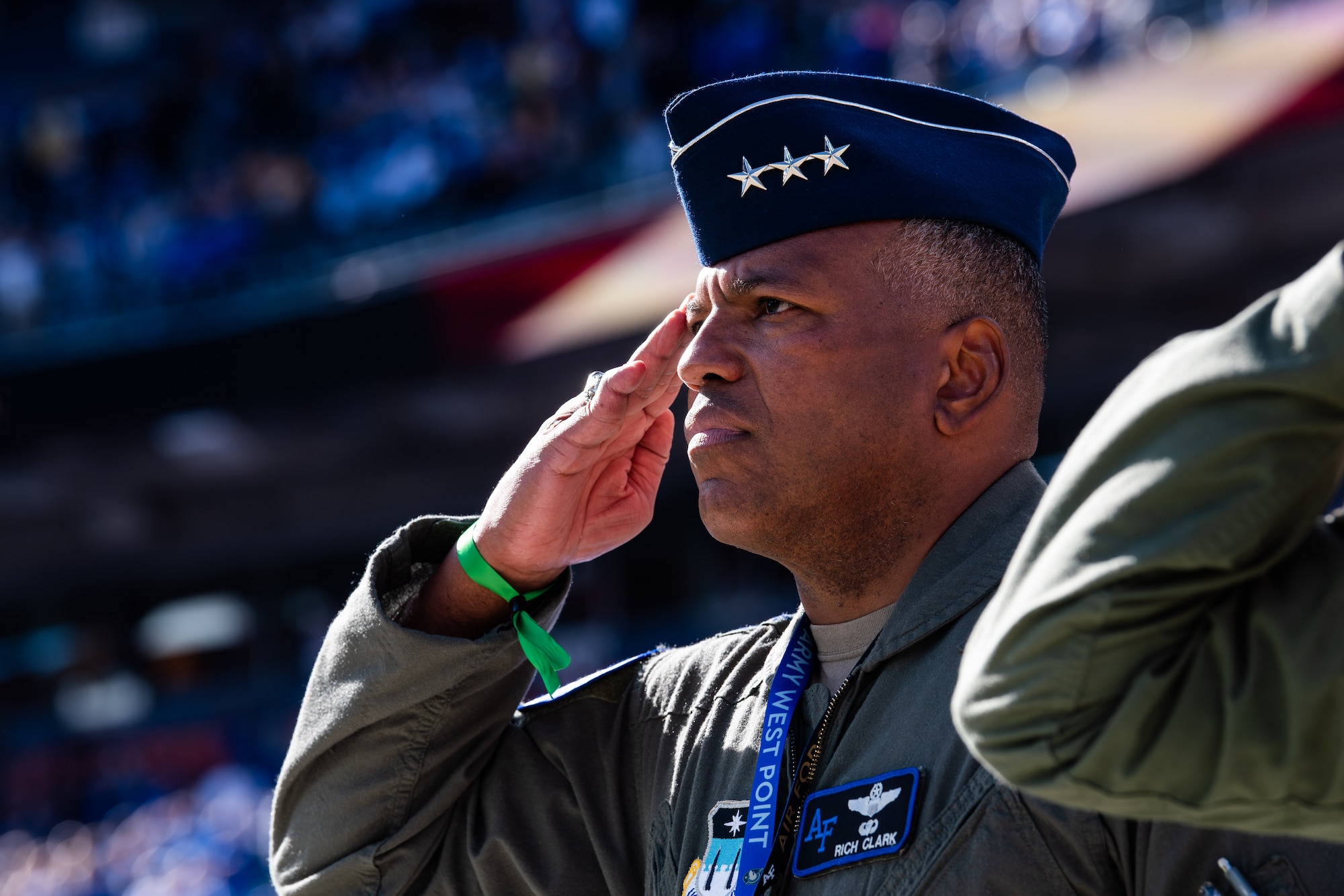Superintendent Lt. Gen. Richard Clark salutes during the National Anthem at the U.S. Air Force Academy football game against Army in Empower Field in Denver.