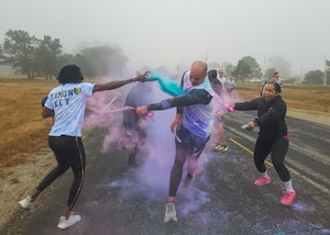 Space Launch Delta 30 members enjoy spraying each other with paint during a fun run in celebration of Pride Month during the monthly Delta Dash at Vandenberg Space Force Base.