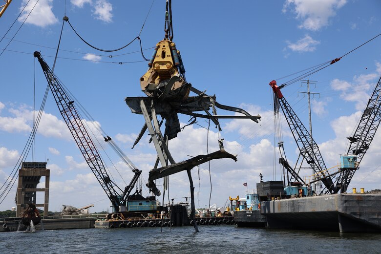 The Chesapeake 1000 (“Chessy”) floating crane equipped with “Gus” the hydraulic grabber, wrestle a 90-ton piece of residual wreckage Friday morning, June 7, 2024, from the Fort McHenry Federal Channel. Taking roughly 45 minutes to unfold, Chessy and Gus slowly lift the mangled steel high above the Patapsco River, so a waiting barge can move underneath, allowing the wreckage to be safely lowered onto the barge for immediate processing by waiting hydraulic sheers.