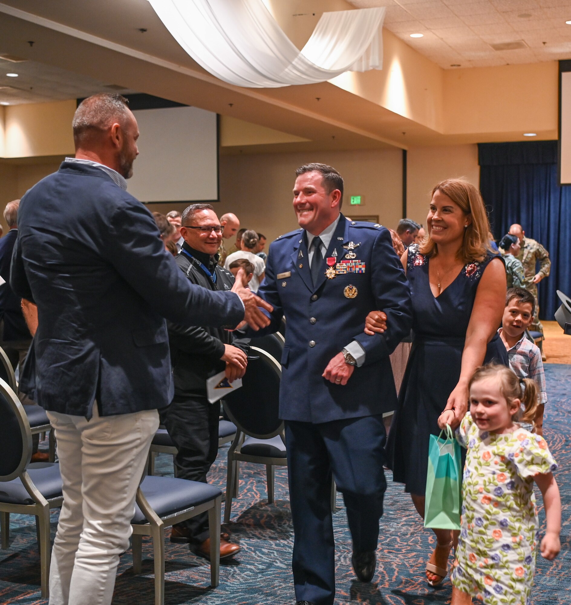 Space Launch Delta 30 operations vice commander, his wife and children say farewell to the guests at the end of his retirement ceremony at Vandenberg Space Force Base.