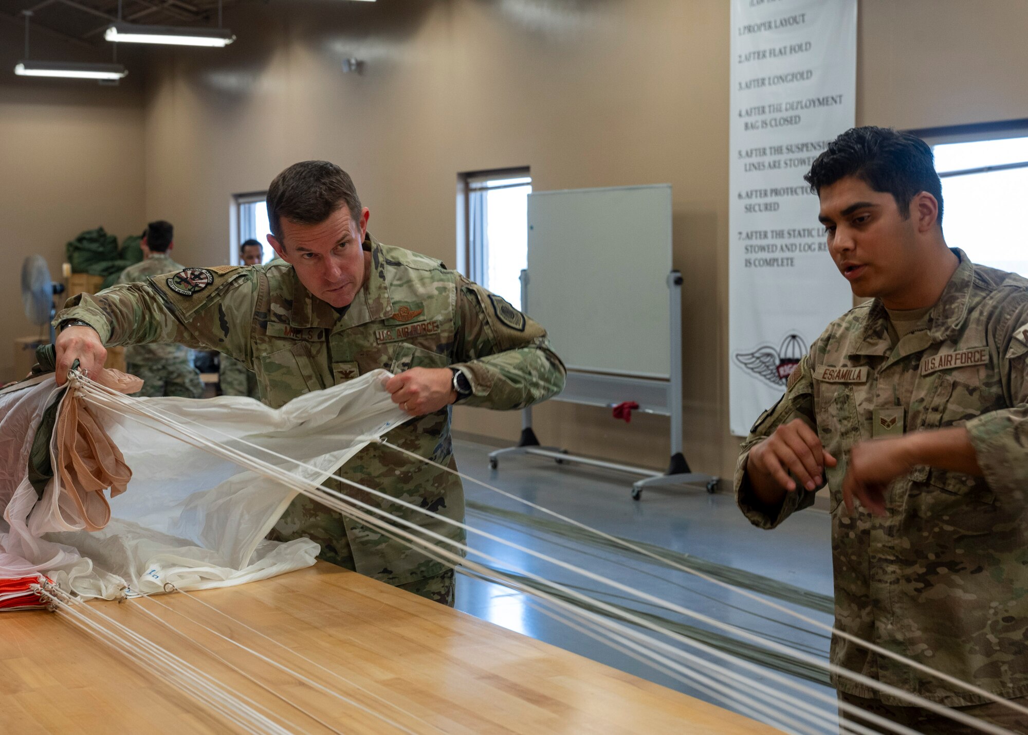 U.S. Air Force Col. Scott Mills, 355th Wing commander, learns about an Airman's job during the Airman for a Day program at Davis-Monthan Air Force Base, Ariz., June 6 , 2024. Mills spent time getting to know Airmen from the 563rd Operations Support Squadron and what they do for the Air Force in support of flying missions. (U.S. Air Force photo by Airman 1st Class William Finn V)