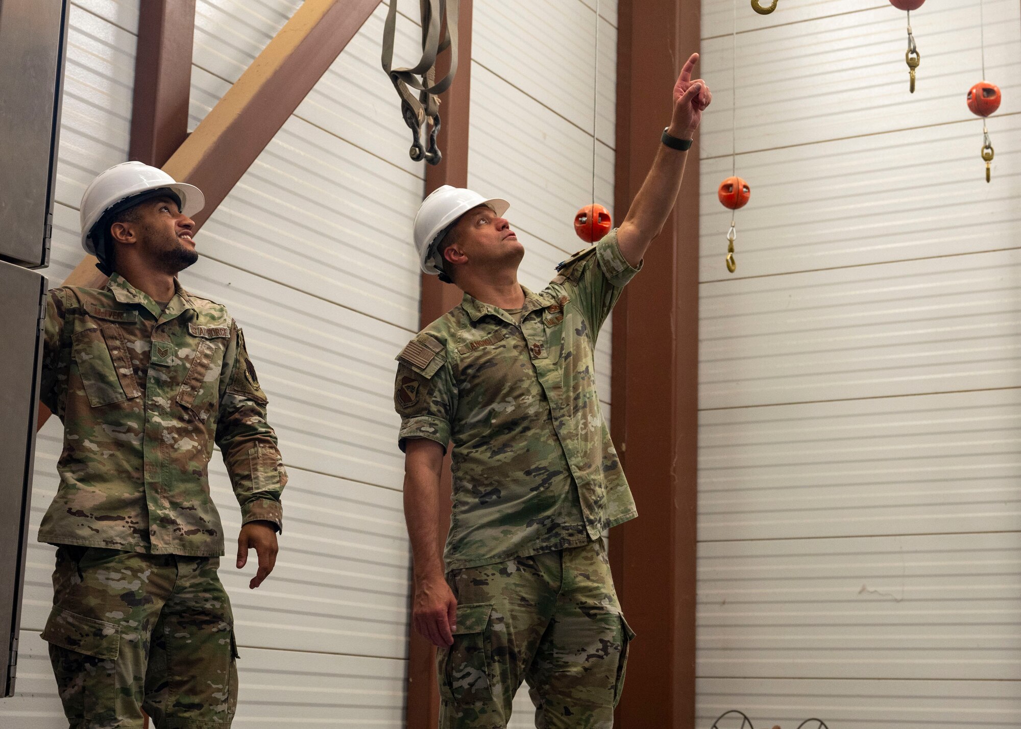 A U.S. Air Force Airman assigned to the 563rd Operations Support Squadron shows the parachute drying tower to Chief Master Sgt. Andre Ancic, 355th Maintenance Group senior enlisted leader, at Davis-Monthan Air Force Base, Ariz., June 6 , 2024. The Airmen from the 563rd OSS spent time demonstrating what job duties they perform on a day-to-day basis to Ancic such as packing and preparing parachutes.  (U.S. Air Force photo by Airman 1st Class William Finn V)