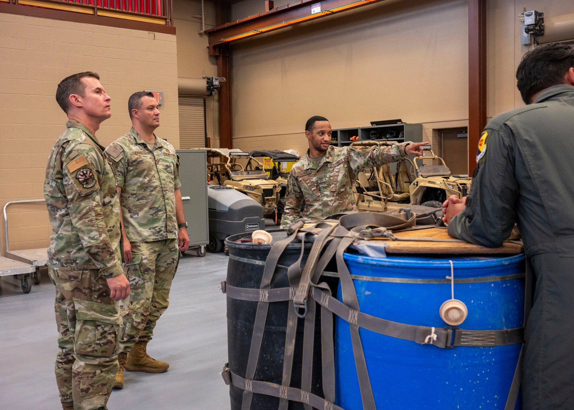 A U.S. Air Force Airman assigned to the 563rd Operations Support Squadron talks about his job to Col. Scott Mills, 355th Wing commander, and Chief Master Sgt. Andre Ancic, 355th Maintenance Group senior enlisted leader, during the Airman for a Day program at Davis-Monthan Air Force Base, Ariz., June 6 , 2024. The Airman for a Day program was designed to connect Airmen with base leadership.  (U.S. Air Force photo by Airman 1st Class William Finn V)