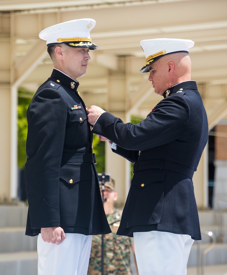 U.S. Marine Corps Major Gen. W. “Wes” E. Souza III, right, Commanding General of U.S. Marine Corps Forces, Korea, pins a Meritorious Service Medal onto Lt. Col. Alexander Cole, an assistant chief of staff also with MARFORK, during a retirement ceremony on U.S. Army Garrison Humphreys, South Korea, May 28, 2024. MARFORK is the U.S. Marine Corps service component for United States Forces Korea and United Nations Command. MARFORK commands all U.S. Marine Forces assigned to USFK and UNC; as well as advises on the Marine Corps capabilities, support and proper employment of Marine Forces. (U.S. Marine Corps photo by Cpl. Dean Gurule)