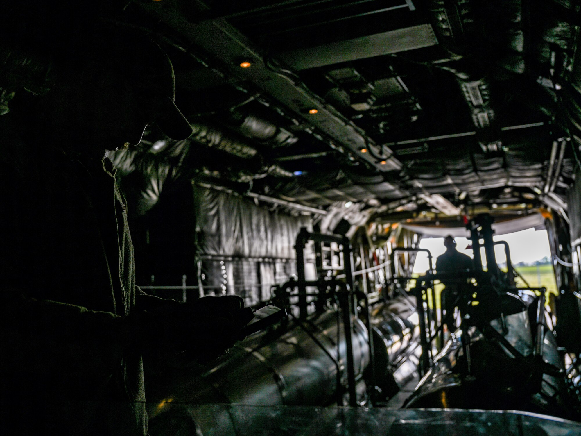 U.S. aerial spray qualified loadmasters assigned to the 757thAirlift Squadron conduct preflight checks on a 910th Airlift Wing Modular Aerial Spray System, May 29, 2024, onboard an aerial spray modified C-130H Hercules aircraft parked at Williston Basin International Airport, North Dakota.