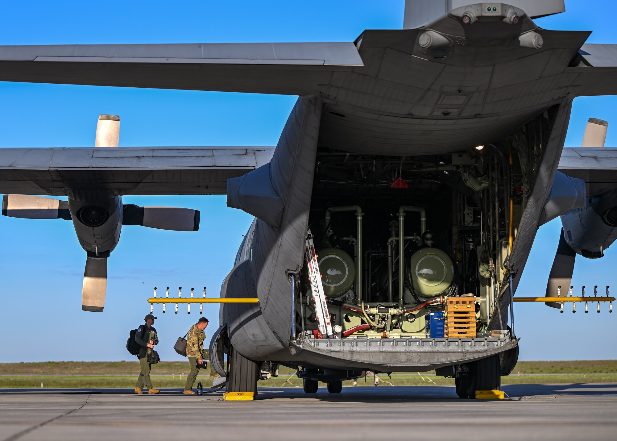 U.S. aircrew members assigned to the 910th Operations Group, board a 910th Airlift Wing aerial spray-modified C-130H Hercules aircraft, May 29, 2024, parked at Williston Basin International Airport, North Dakota.