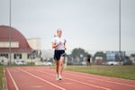 woman runs around outdoor track
