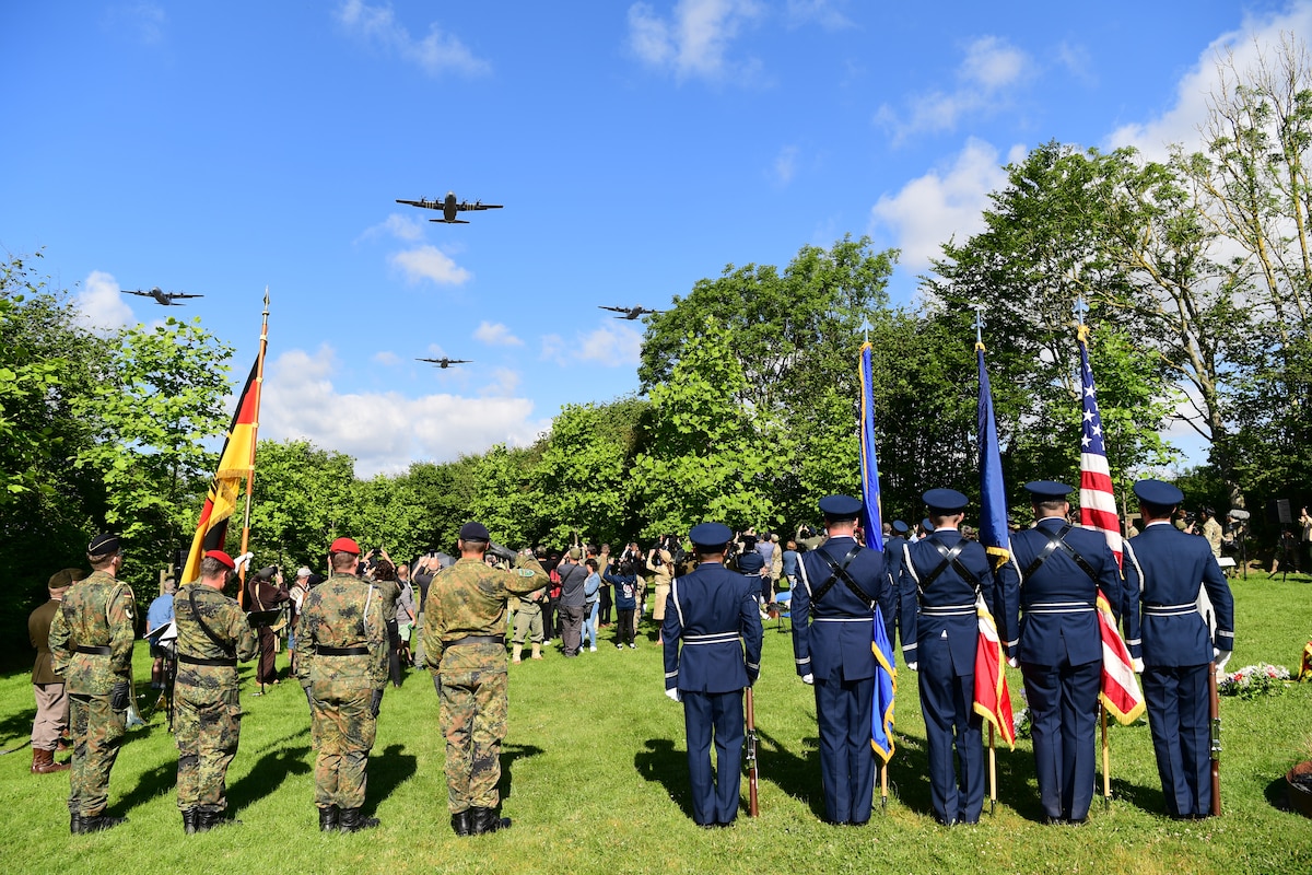 A formation of C-130J ’s perform a flyover during a C-47 Memorial Garden Ceremony in Picauville, France, June 7, 2024. The ceremony honored the lives of the lost service members on June 6th 1944. (U.S. Air Force photo by Senior Airman Noah Sudolcan)