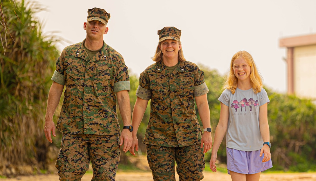 Lt. Col. Scott Blyleven, an operational planner with 3d MEB, and Lt. Col. Melissa Blyleven, a logistics planner with III MEF, walk with their daughter, Hanna, at Camp Courtney Beach, Okinawa, Japan, April 15, 2024.
