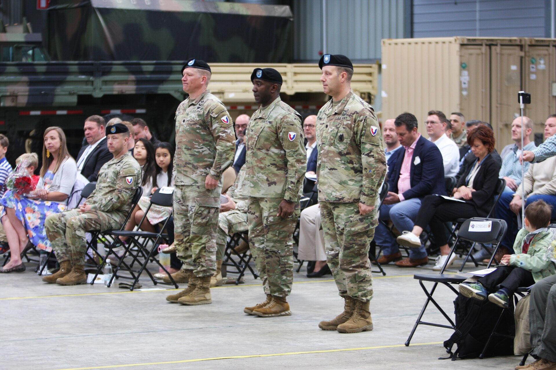 The commander of the 405th Army Field Support Brigade, Col. Ernest Lane II, stands in the center between Lt. Col. Blake Smith and Lt. Col. George, at their change of command ceremony. Smith relinquished command of Army Field Support Battalion-Benelux to Horne during the ceremony June 10 at the Eygelshoven Army Prepositioned Stocks-2 worksite in the Netherlands. (photo by Rob Vankan, Dutch Ministry of Defense)