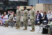 The commander of the 405th Army Field Support Brigade, Col. Ernest Lane II, stands in the center between Lt. Col. Blake Smith and Lt. Col. George, at their change of command ceremony. Smith relinquished command of Army Field Support Battalion-Benelux to Horne during the ceremony June 10 at the Eygelshoven Army Prepositioned Stocks-2 worksite in the Netherlands. (photo by Rob Vankan, Dutch Ministry of Defense)