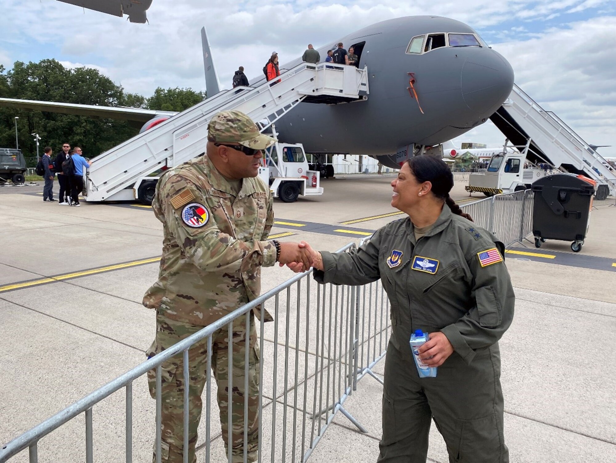 U.S. Air Force Maj. Gen. Dana Nelson, mobilization assistant to the deputy commander of United States Air Forces in Europe – Air Force Africa, shakes hands with Master Sgt. Jerome Saunders, a member of the Air Force Installation and Mission Support Center, Detachment 4, near a U.S. Air Force KC-46 Pegasus aircraft at the Berlin Innovation & Leadership in Aerospace trade show and air show, June 5, 2024, in Berlin, Germany. The U.S. Air Force, Army and Navy had aircraft on display at the show to support the longstanding partnership with Germany. (U.S. Air Force photo by Senior Master Sgt. Dan Heaton)