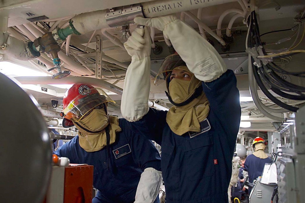 Sailors train during a general quarters drill aboard USS Halsey (DDG 97).