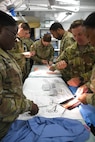 Soldiers assigned to the 75th Field Hospital in Baumholder, Germany, practice suture skills during DEFENDER 24, a large-scale exercise in Europe that focuses on the strategic deployment of continental, U.S.-based forces, employment of Army Prepositioned Stocks, and interoperability with Allies and partners at exercise locations across 13 European countries. (Ellen Crown)