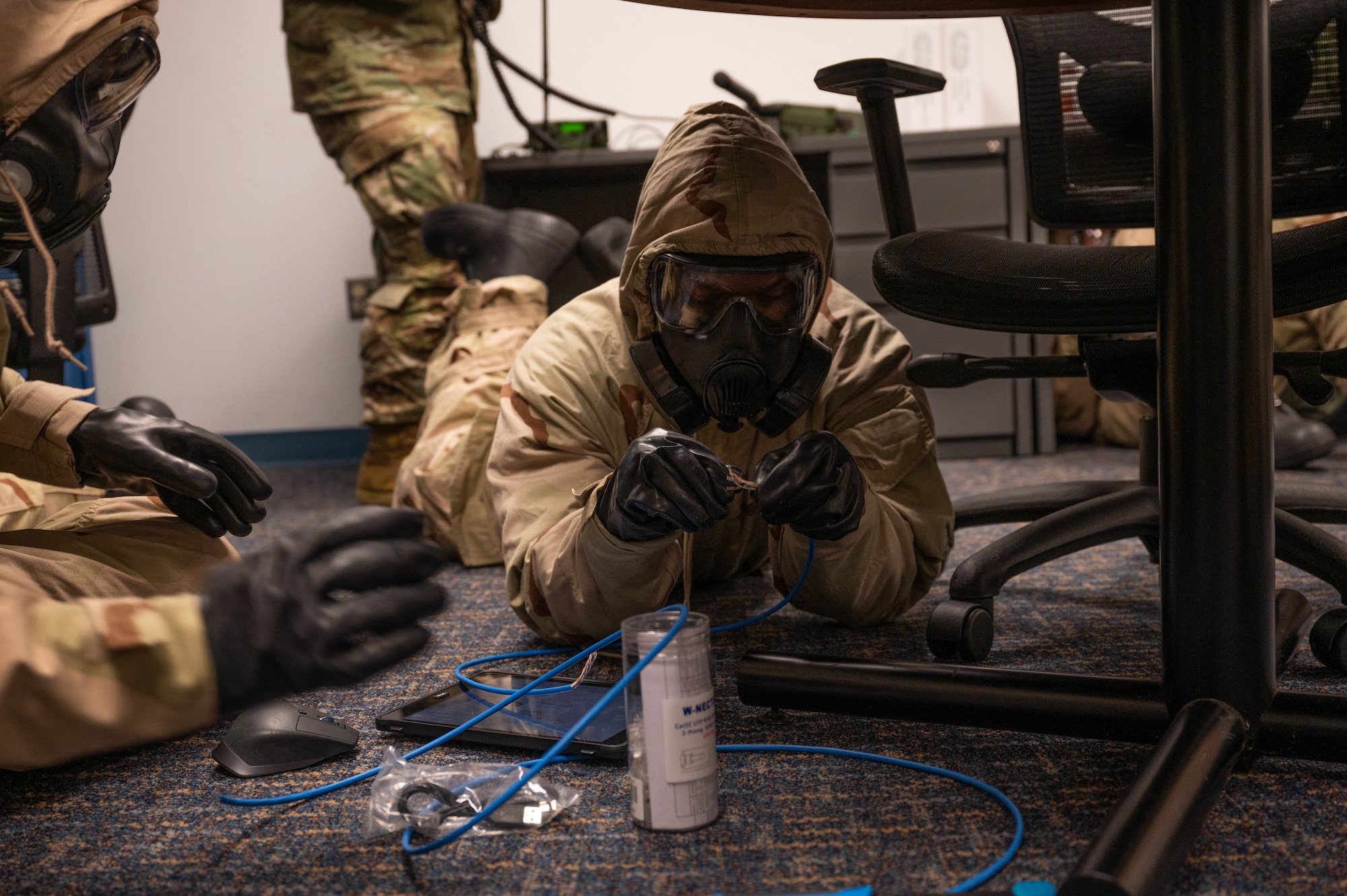 Reserve Citizen Airmen from the 45th Aeromedical Evacuation Squadron set-up network cables while donning Mission Oriented Protective Posture during the Super Unit Training Assembly held on MacDill AFB, Florida, June 1-4. This training prepared members to utilize their skills while under pressure to ensure they are mission ready. (U.S. Air Force Photo by Staff Sgt. Alexis Suarez)