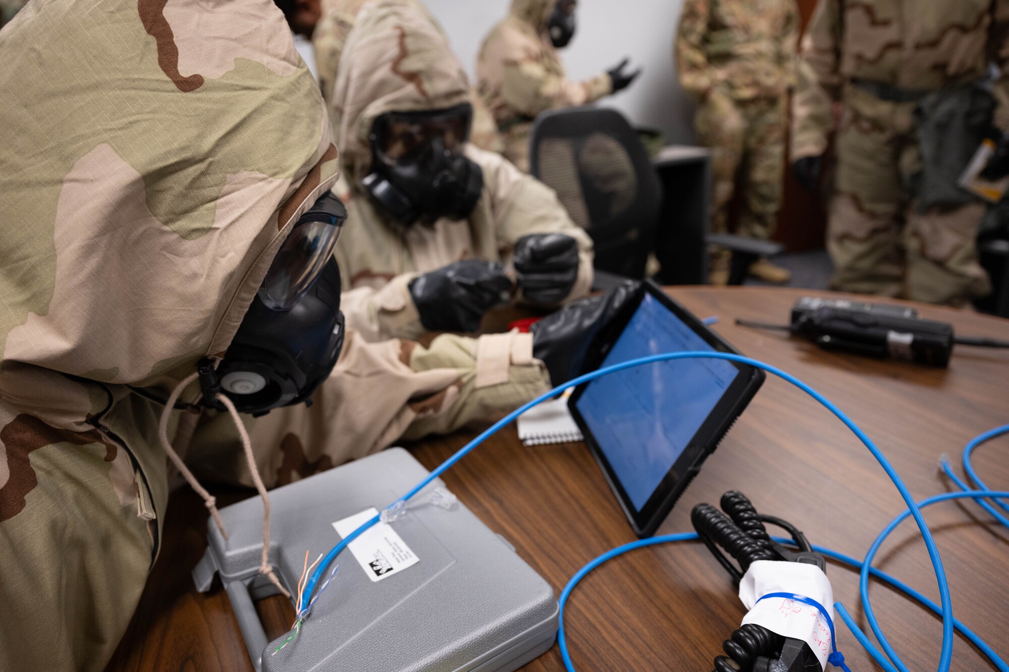 Reserve Citizen Airmen from the 45th Aeromedical Evacuation Squadron set-up network cables while donning Mission Oriented Protective Posture during the Super Unit Training Assembly held on MacDill AFB, Florida, June 1-4. This training prepared members to utilize their skills while under pressure to ensure they are mission ready. (U.S. Air Force Photo by Staff Sgt. Alexis Suarez)