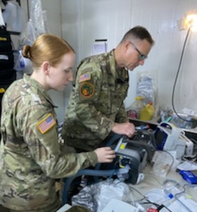 Sgt. Nicolette Whisker, a biomedical equipment specialist with the 51st Medical Logistics Company out of Fort Liberty, North Carolina, inspects equipment to ensure everything is in working order for the 909th Forward Resuscitative and Surgical Detachment, an Army Reserve unit from Illinois. (Courtesy Maj. Raquel Guinta)