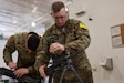 Sgt. Jason R. Paglia and Sgt. Charles C. Roberts, biomedical equipment specialists with the U.S. Army Medical Materiel Agency’s Medical Maintenance Operations Division (MMOD-UT), practice assembling the M249 Squad Automatic Weapon during the Best Warrior Competition on Aberdeen Proving Ground, Maryland, May 8. Paglia and Roberts, who are both stationed at Hill Air Force Base, Utah, also competed for the best time in assembling and disassembling the M17 Pistol and the M4 Carbine Assault Rifle. (U.S. Army photo by Marshall R. Mason)