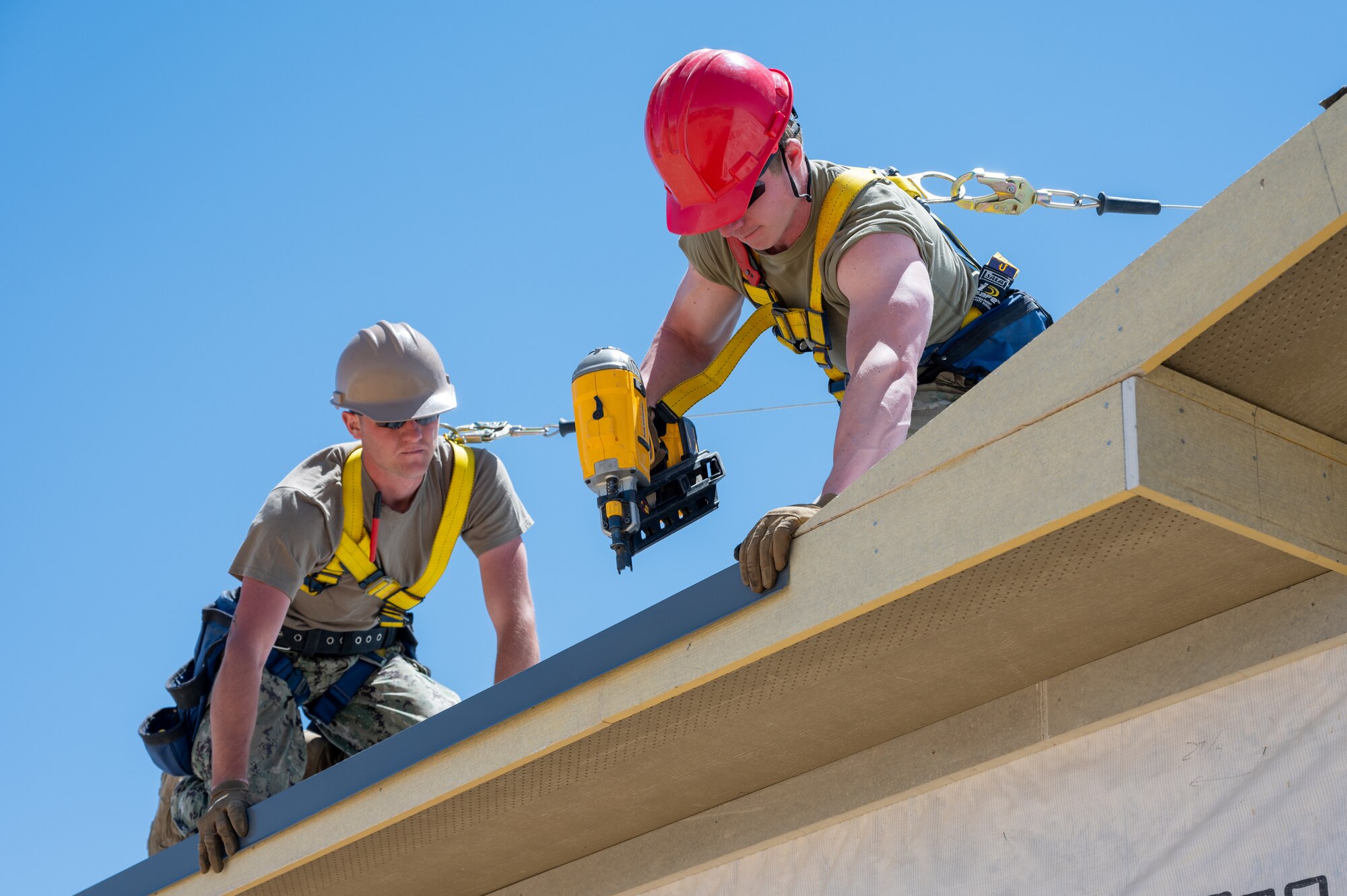 Man nails roof.